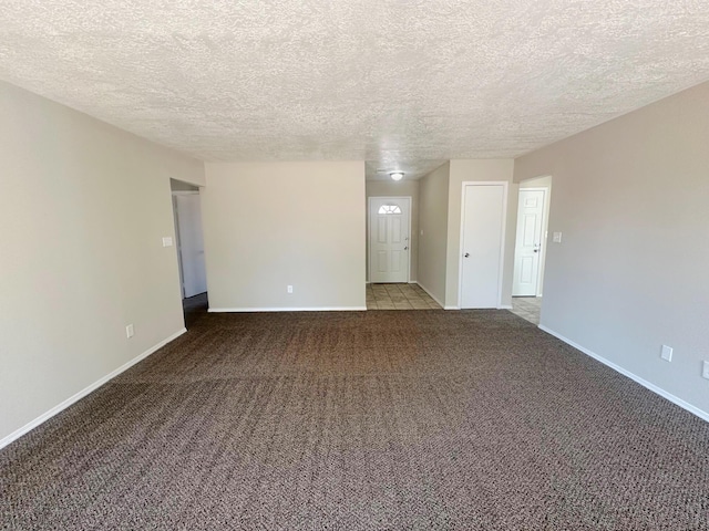 spare room with carpet and a textured ceiling