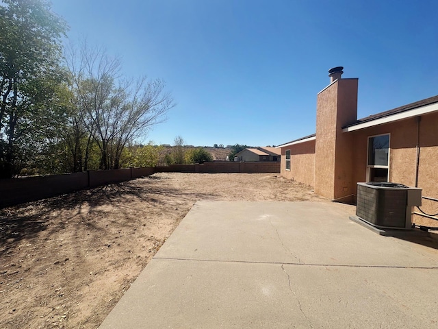 view of yard featuring central air condition unit and a patio area