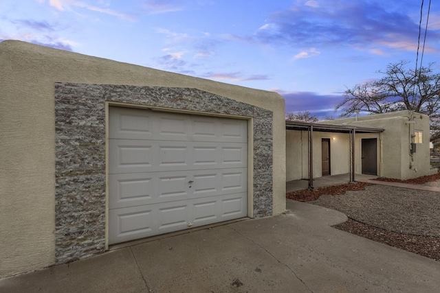 view of garage at dusk