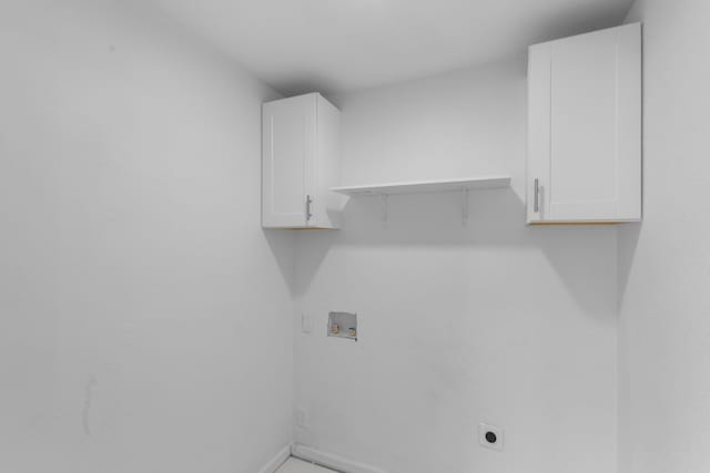 clothes washing area with washer hookup, hookup for an electric dryer, and cabinets