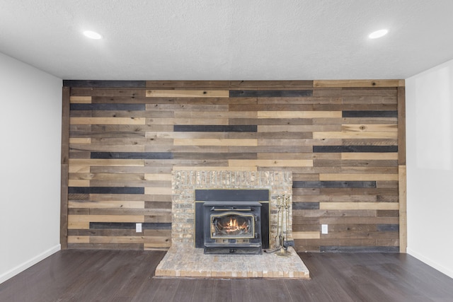 details with wood-type flooring, a wood stove, and wooden walls