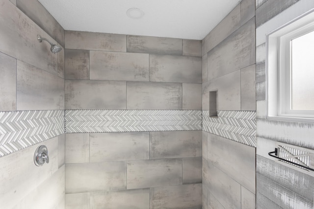 interior details featuring tiled shower