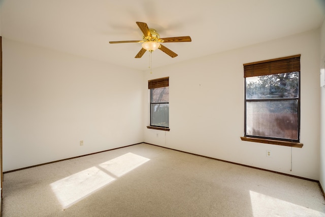 unfurnished room featuring ceiling fan and light colored carpet