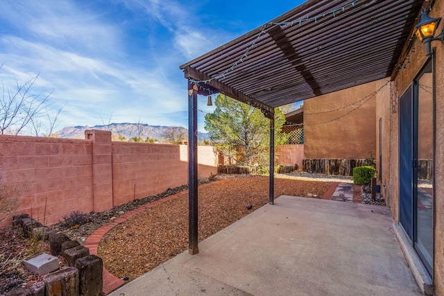 view of patio / terrace with a pergola and a mountain view