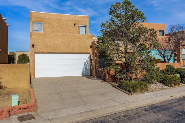 pueblo-style home featuring a garage