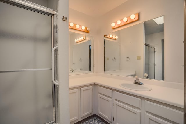 bathroom featuring vanity and a shower with door