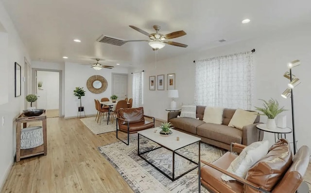 living room with ceiling fan and light hardwood / wood-style floors