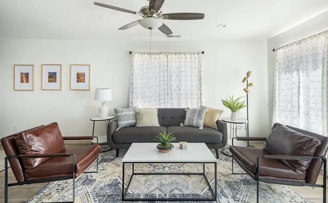 living room featuring light hardwood / wood-style floors and ceiling fan