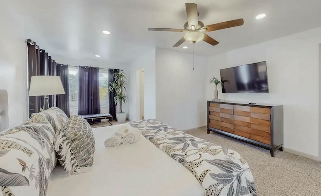 bedroom with ceiling fan and light colored carpet