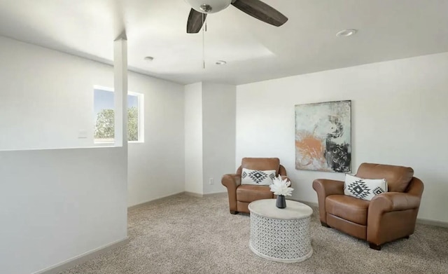 sitting room featuring light carpet and ceiling fan