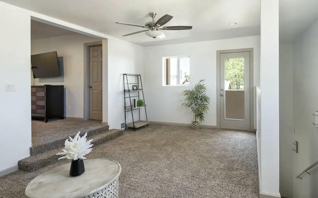 interior space with carpet flooring and ceiling fan