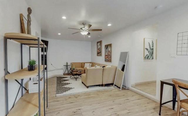 living room with ceiling fan and light wood-type flooring