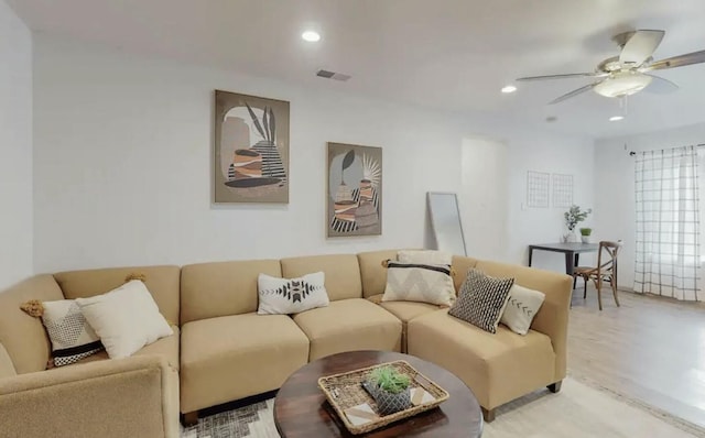 living room featuring ceiling fan and light hardwood / wood-style floors