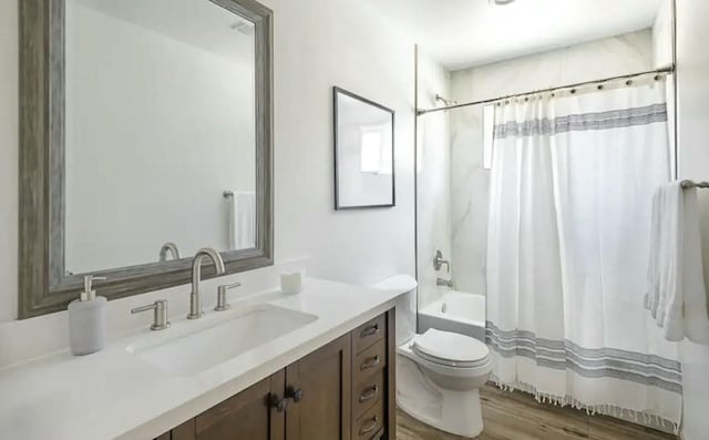 full bathroom with vanity, wood-type flooring, shower / bath combo, and toilet