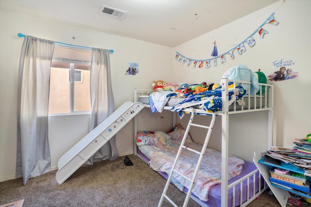 carpeted bedroom featuring visible vents