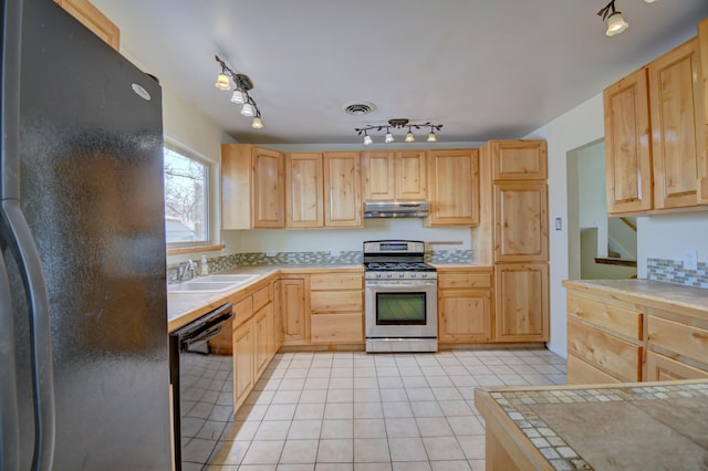 kitchen featuring light brown cabinets, tile countertops, and black appliances