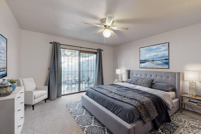 bedroom featuring access to outside, ceiling fan, light colored carpet, and a textured ceiling