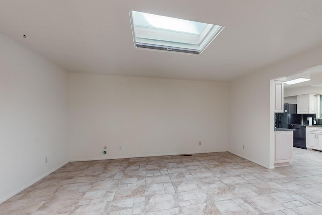 spare room featuring a skylight