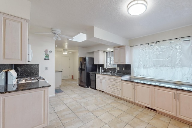 kitchen featuring sink, tasteful backsplash, a textured ceiling, light tile patterned floors, and black appliances