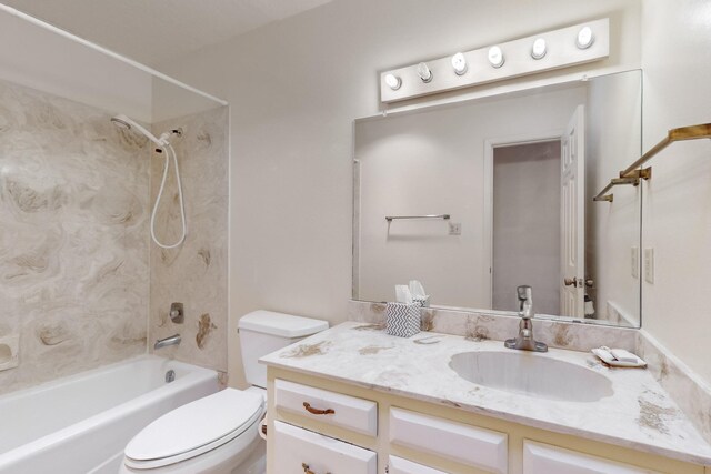 full bathroom with vanity, tiled shower / bath combo, and toilet