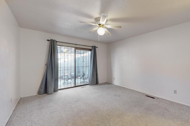 unfurnished room with ceiling fan and light carpet