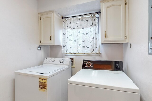 washroom with cabinets and washer and clothes dryer