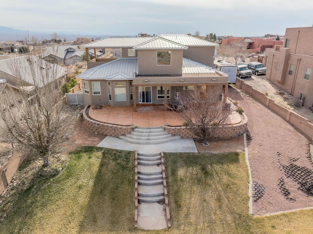 rear view of house featuring a lawn and a patio area