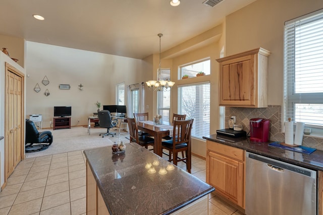 kitchen with tasteful backsplash, light tile patterned floors, decorative light fixtures, a notable chandelier, and dishwasher