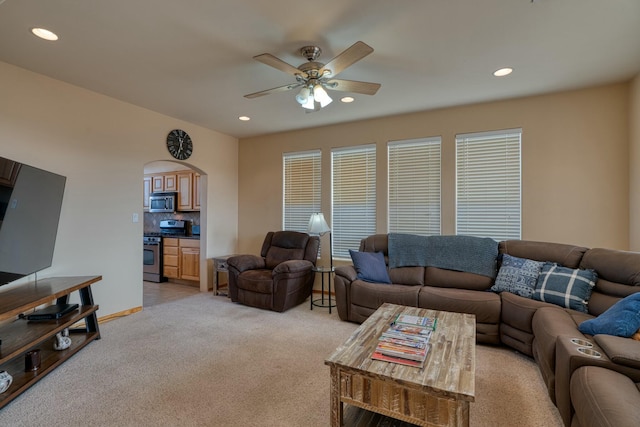 carpeted living room featuring ceiling fan