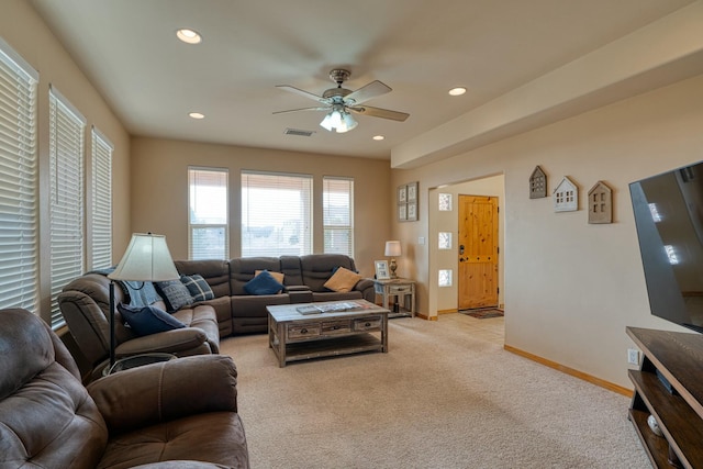 carpeted living room with ceiling fan