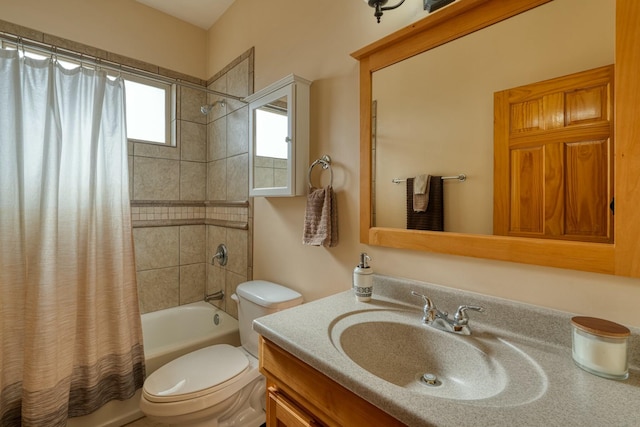 full bathroom featuring shower / bath combo with shower curtain, vanity, and toilet