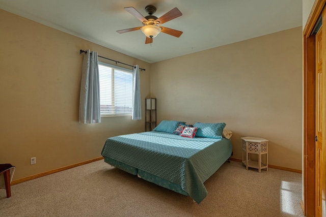 bedroom with ceiling fan, light carpet, and a closet