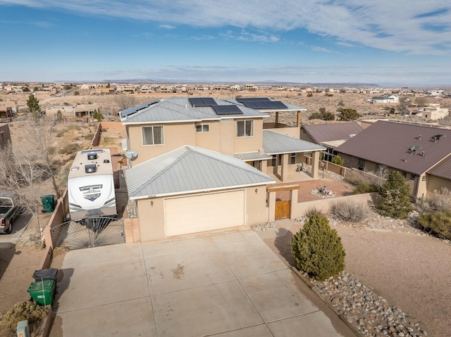 view of front of house featuring a garage and solar panels