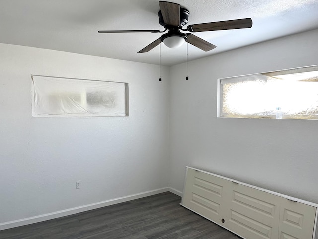 407 E Maloney Ave, Gallup, NM 87301 - empty room with dark wood-type flooring and a ceiling fan