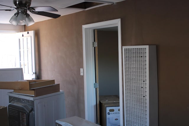 interior space with a heating unit and a ceiling fan