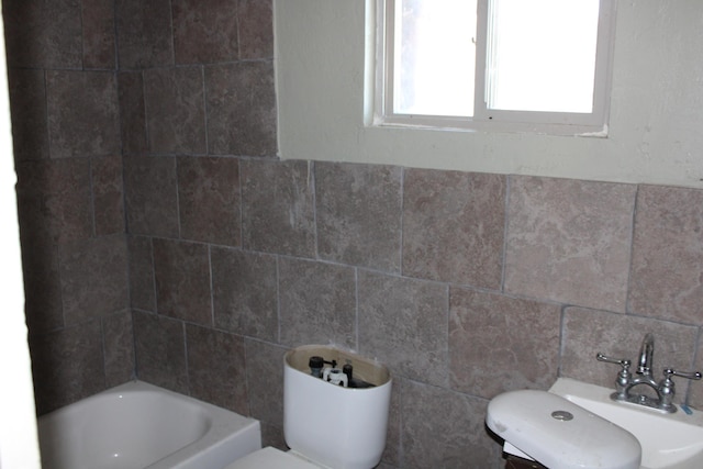 bathroom featuring tile walls and toilet