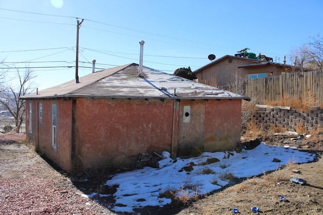 view of property exterior with fence and stucco siding