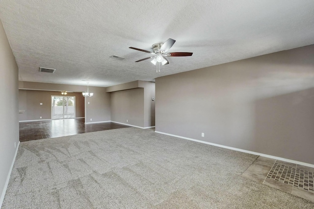 carpeted empty room featuring ceiling fan with notable chandelier and a textured ceiling