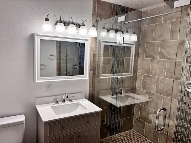 bathroom with vanity, toilet, and walk in shower