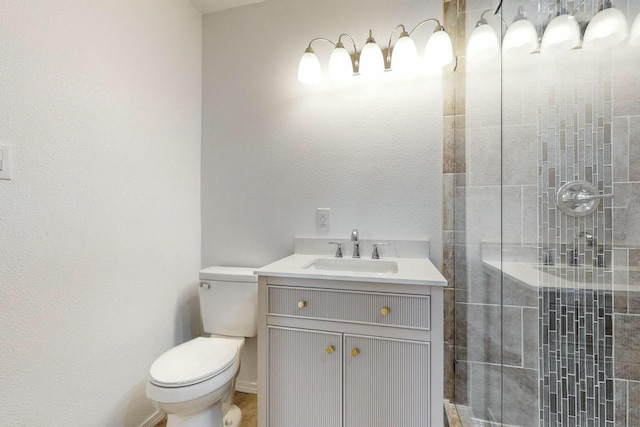 bathroom featuring an enclosed shower, vanity, and toilet