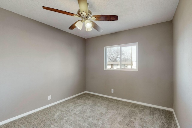 carpeted spare room featuring ceiling fan and a textured ceiling