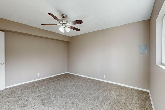 carpeted spare room with ceiling fan