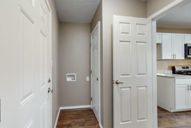 interior space with a textured ceiling and dark wood-type flooring