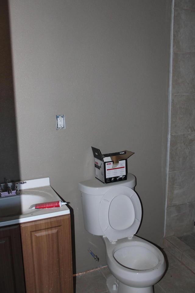 bathroom featuring tile patterned floors, vanity, and toilet