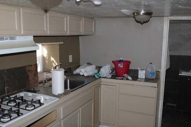 kitchen with white gas cooktop, sink, white cabinets, and ventilation hood