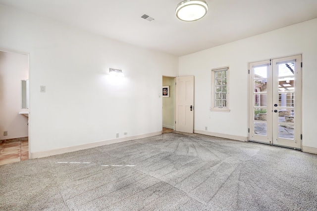 unfurnished room with french doors and carpet flooring