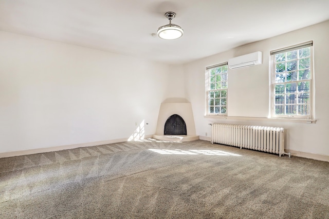 unfurnished living room featuring radiator, a wall unit AC, and carpet floors