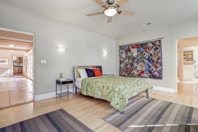 bedroom with ceiling fan and hardwood / wood-style flooring