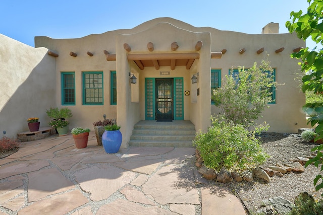 entrance to property featuring a patio