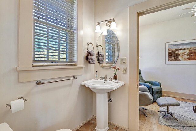 bathroom featuring ceiling fan and hardwood / wood-style flooring